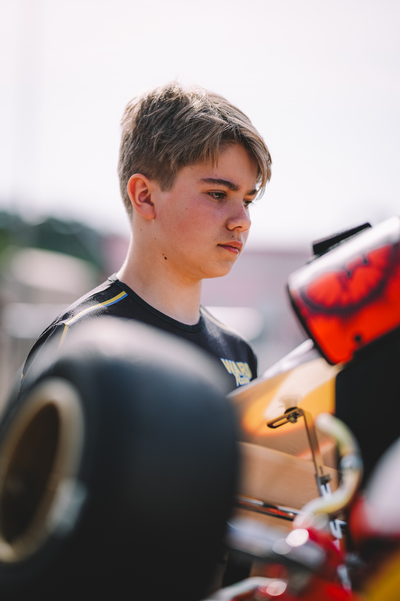 Kevin Pentell preparing beside the kart in the paddock