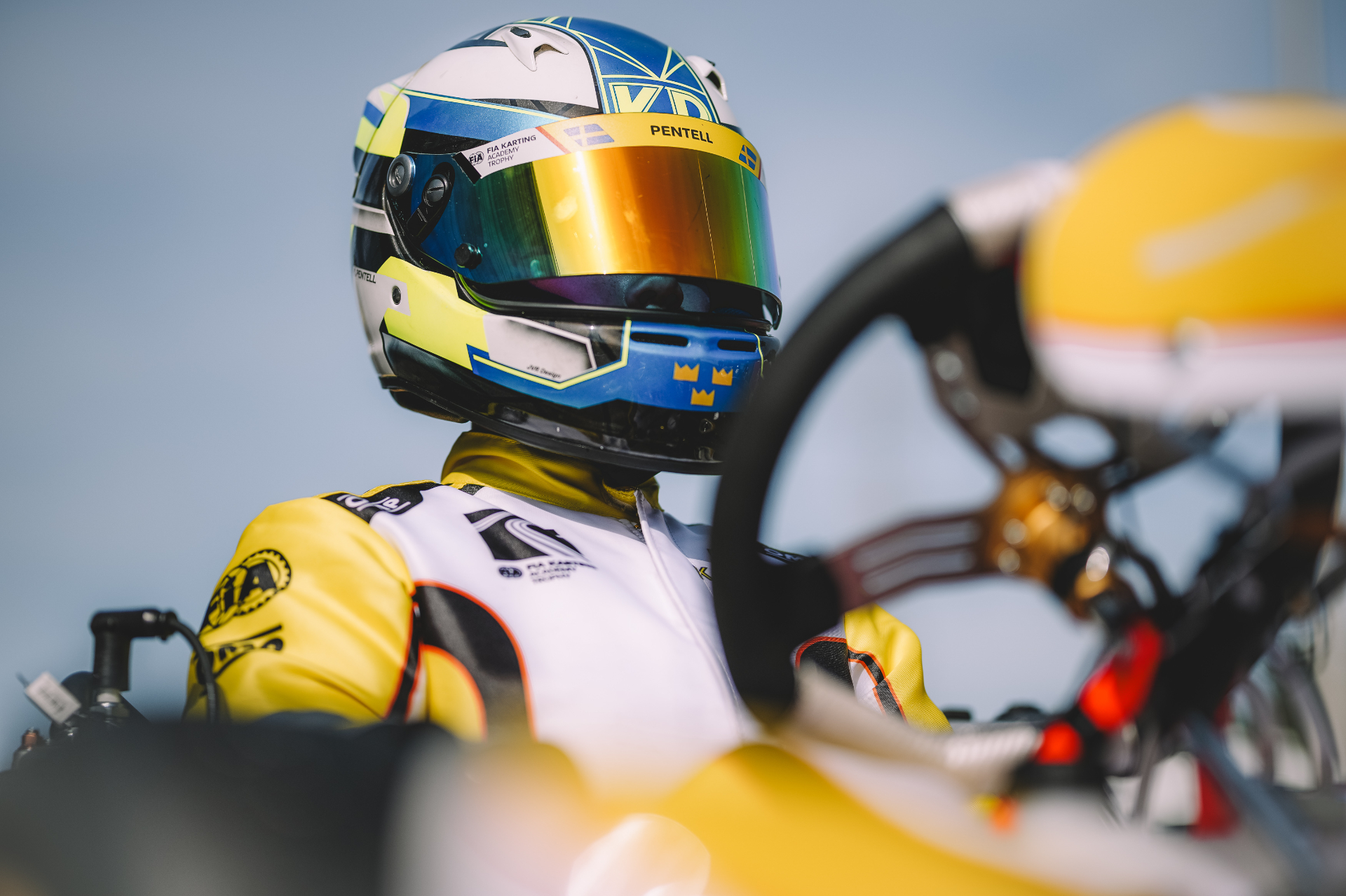 Kevin Pentell in full race gear beside the kart