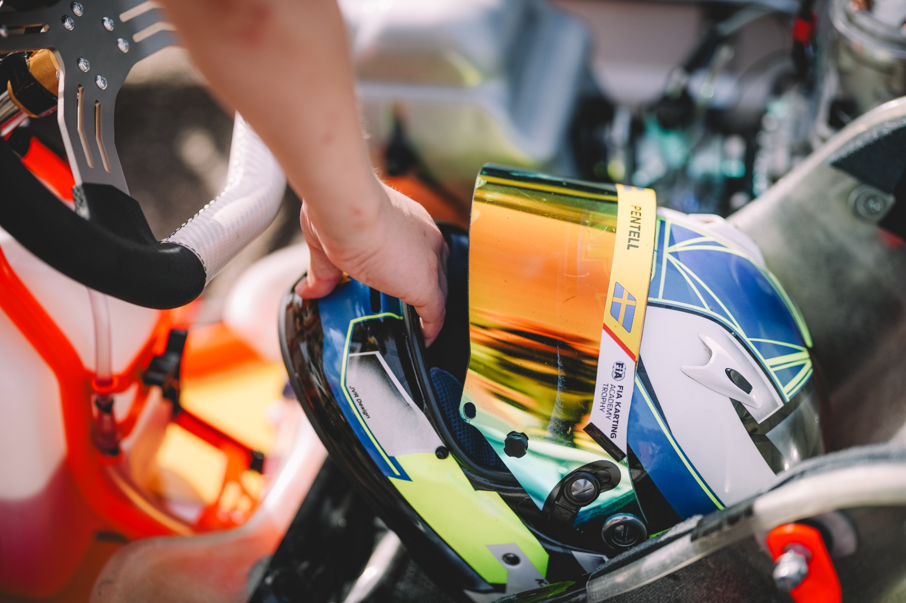 Detail of Kevin Pentell's helmet with Swedish colours and visor reflection